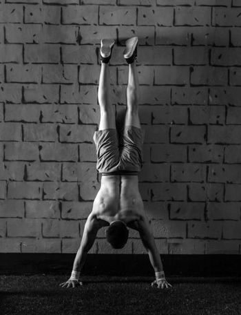 man practicing a handstand